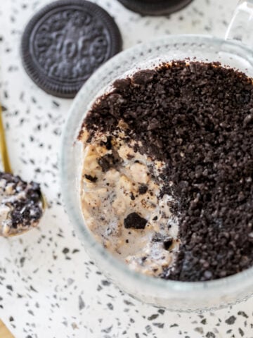 close up of cookies and creams overnight with a spoon of oats on the side