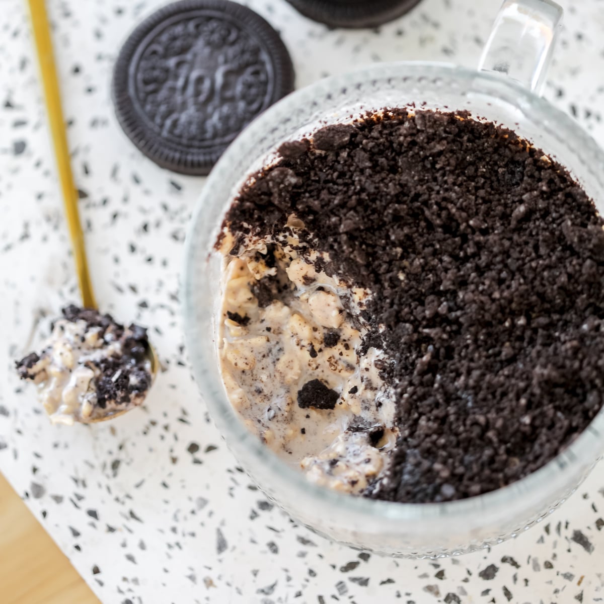close up of cookies and creams overnight with a spoon of oats on the side
