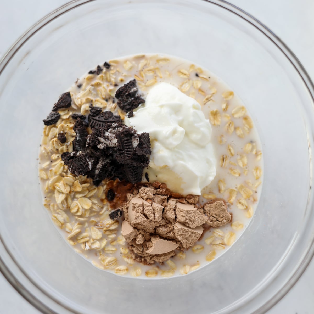 the healthy oreo overnight oats ingredients in a bowl ready to mix