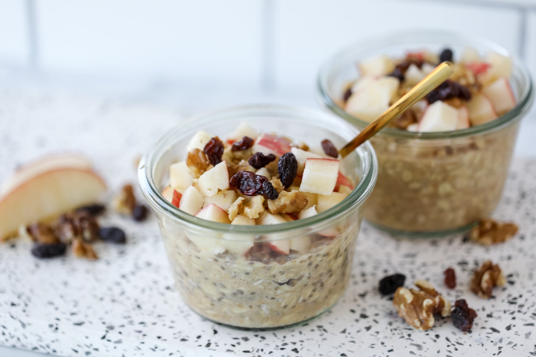 overnight oats with applesauce topped with chopped apples walnuts and raisins