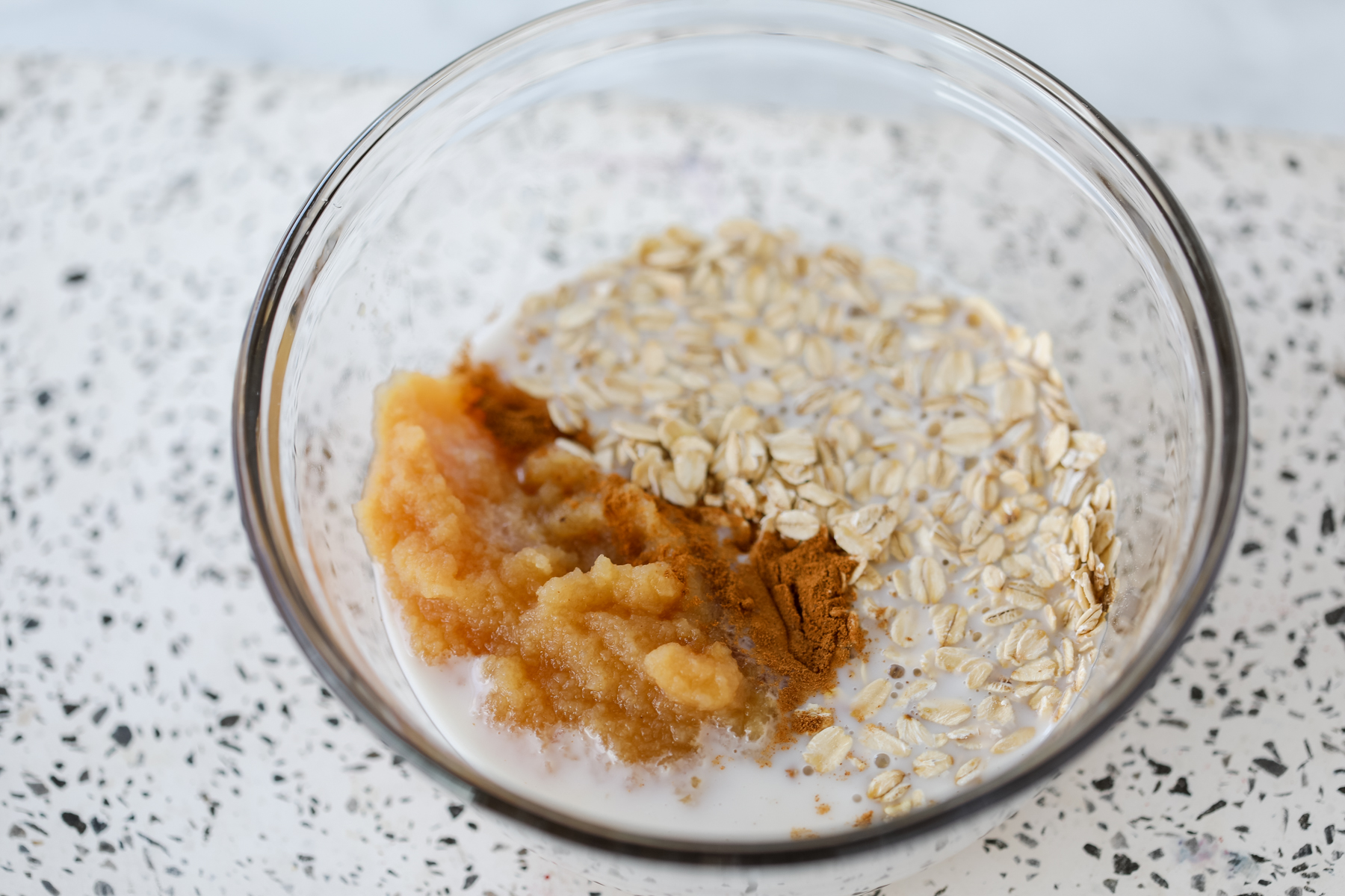 combining the ingredients in a clear mixing bowl