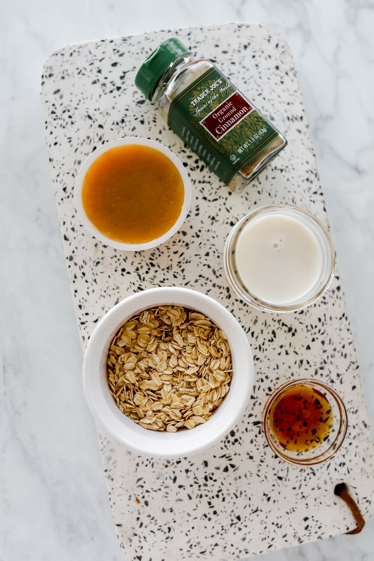 overnight apple sauce oats ingredients on a marble top