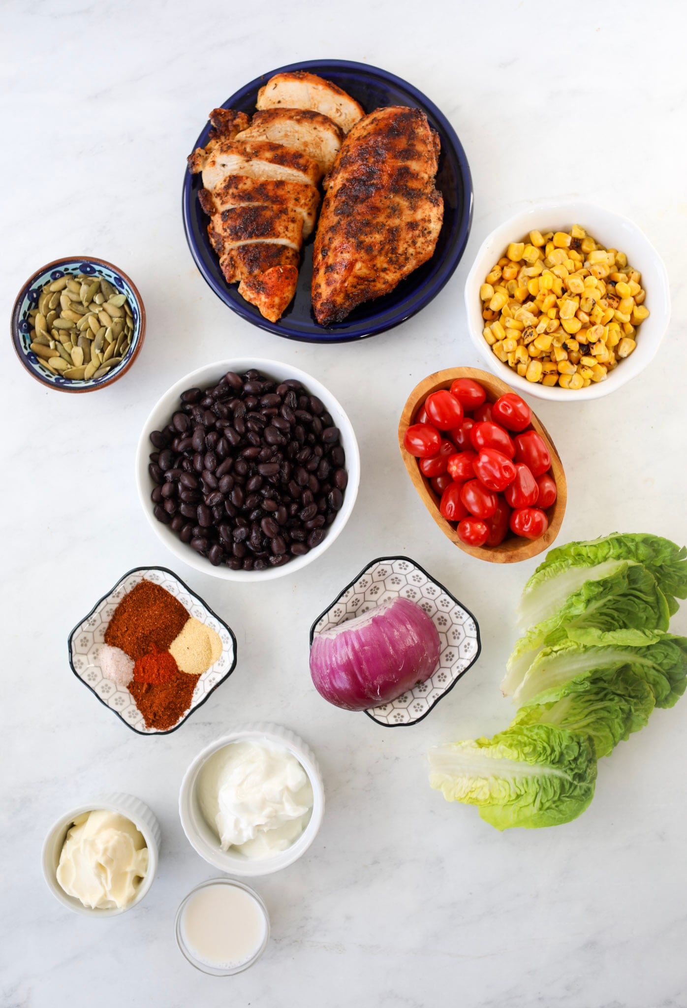 the southwest chicken salad ingredients on a marble cutting board