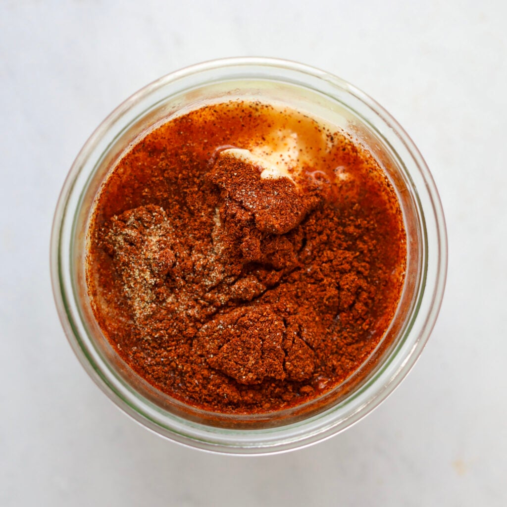 adding the mayo greek yogurt chili garlic and paprika to the small bowl for the southwest salad dressing