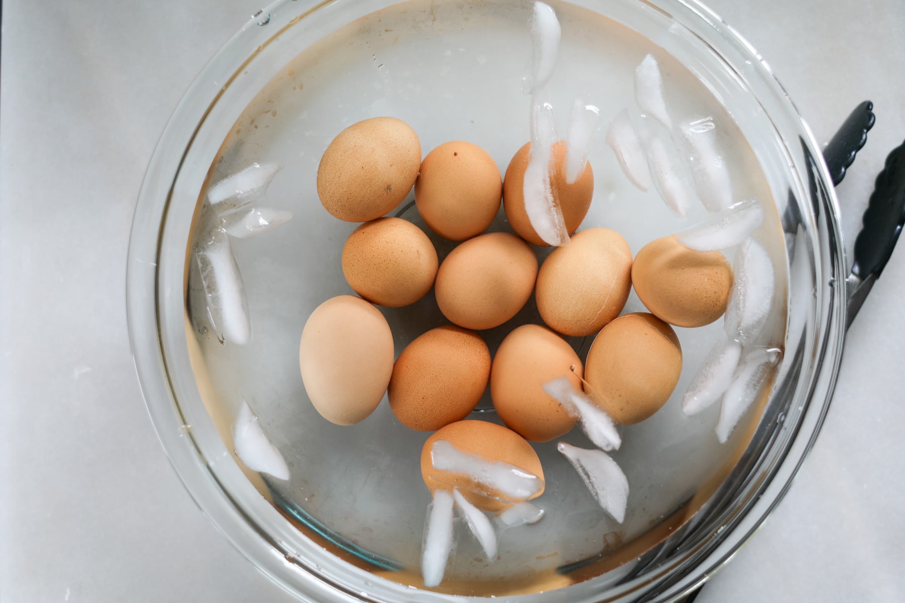 putting the pressure cooker eggs into an ice bath after steaming