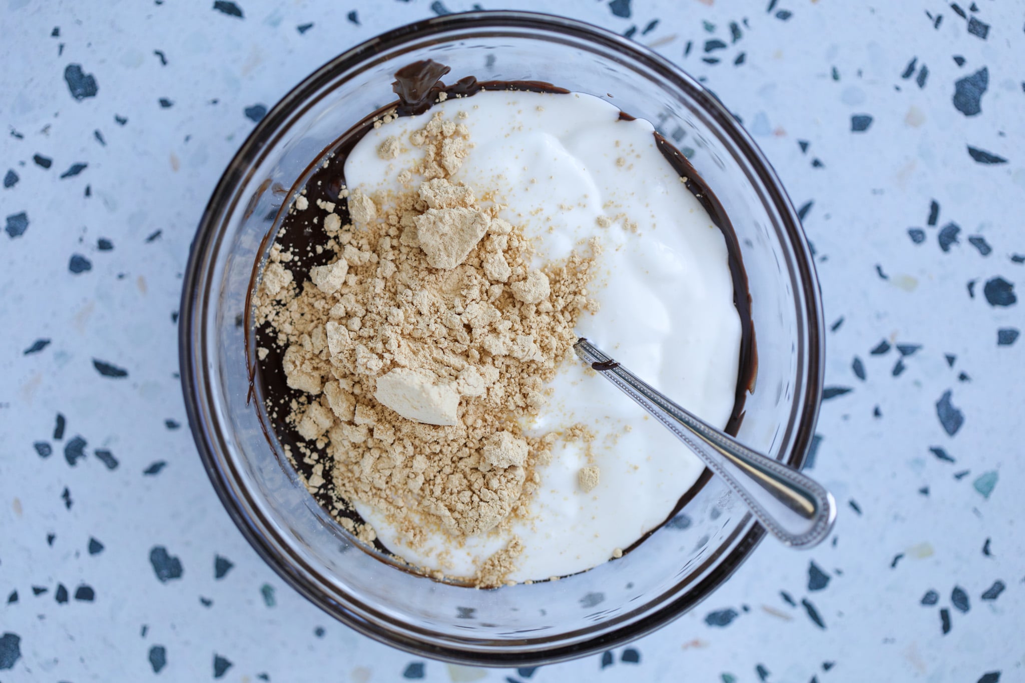 combining the blended cottage cheese, melted chocolate chips, and peanut butter powder in a bowl.