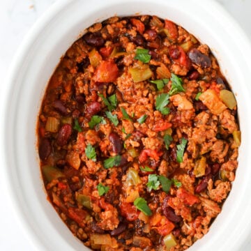 healthy slow cooker turkey chili in a white crock pot